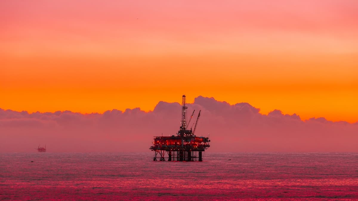 Offshore oil and gas platform at sunset
